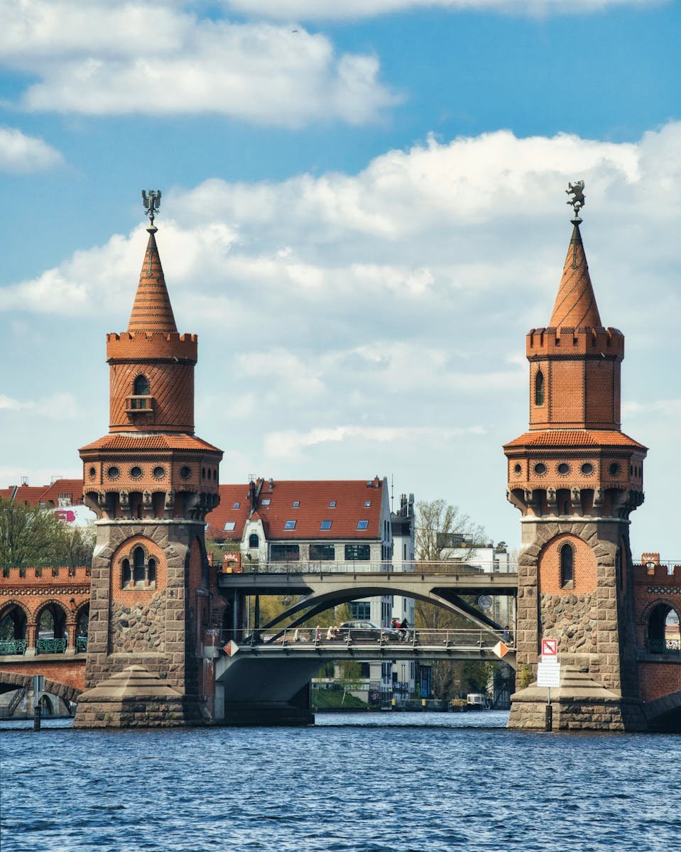Captivating view of the iconic Oberbaum Bridge in Berlin, Germany, with vibrant red towers and a serene river setting.